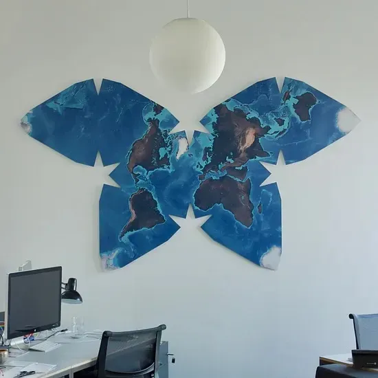 An unusual world map in a butterfly shape, showing the continents arranged in eight connected lobes