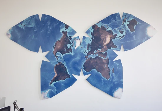 An unusual world map in a butterfly shape, showing the continents arranged in eight connected lobes
